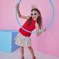 BISBY girl rocking our Sally Skort in our Main Line Marigold floral which features bright yellow, red, and blue floral. This skort also has built in shorts and a elastic waistband for a comfortable fit. Pair it back with our red halter top for a complete look.