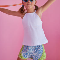 BISBY girl rocking our new track shorts in our Mixed Lawn Floral Pattern. This floral pattern contains blue and green base colors with white floral arrangement all over the shorts. Pair it back perfectly with our white halter top for an active/sporty look.