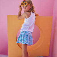 BISBY girl in our Sally Skort in our fun Blue Ripple pattern which has built in shorts and stretchy waistband. Pair it back with our halter top in white for a complete look.