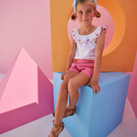 Model can be seen wearing our new Pink Basic Shorts in our rayon blend fabric which has an elastic waistband and pockets. We have paired the Kate Top in our Flower Market Embroidery.