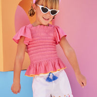 Hot pink ruched smocked top for girls and tweens with orange trim