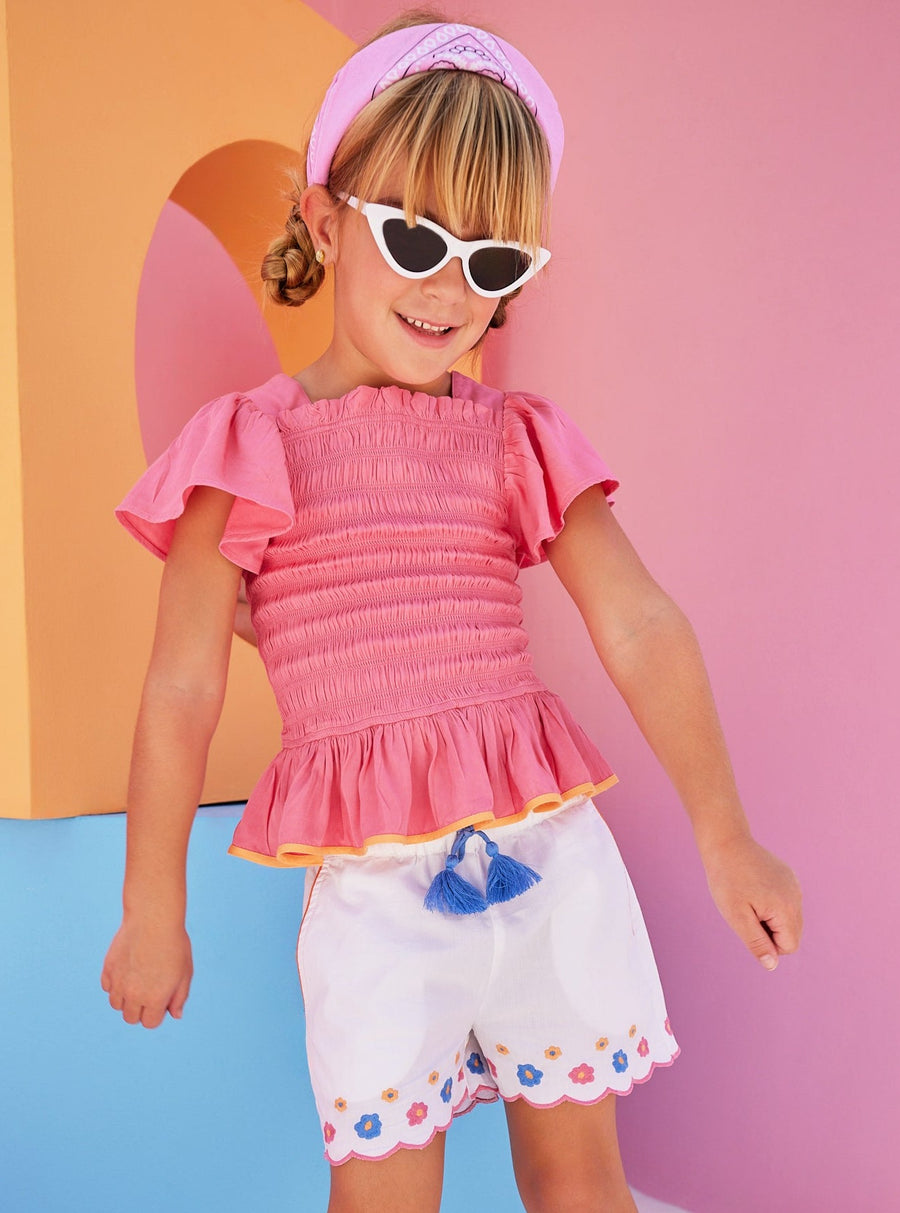 Hot pink ruched smocked top for girls and tweens with orange trim 