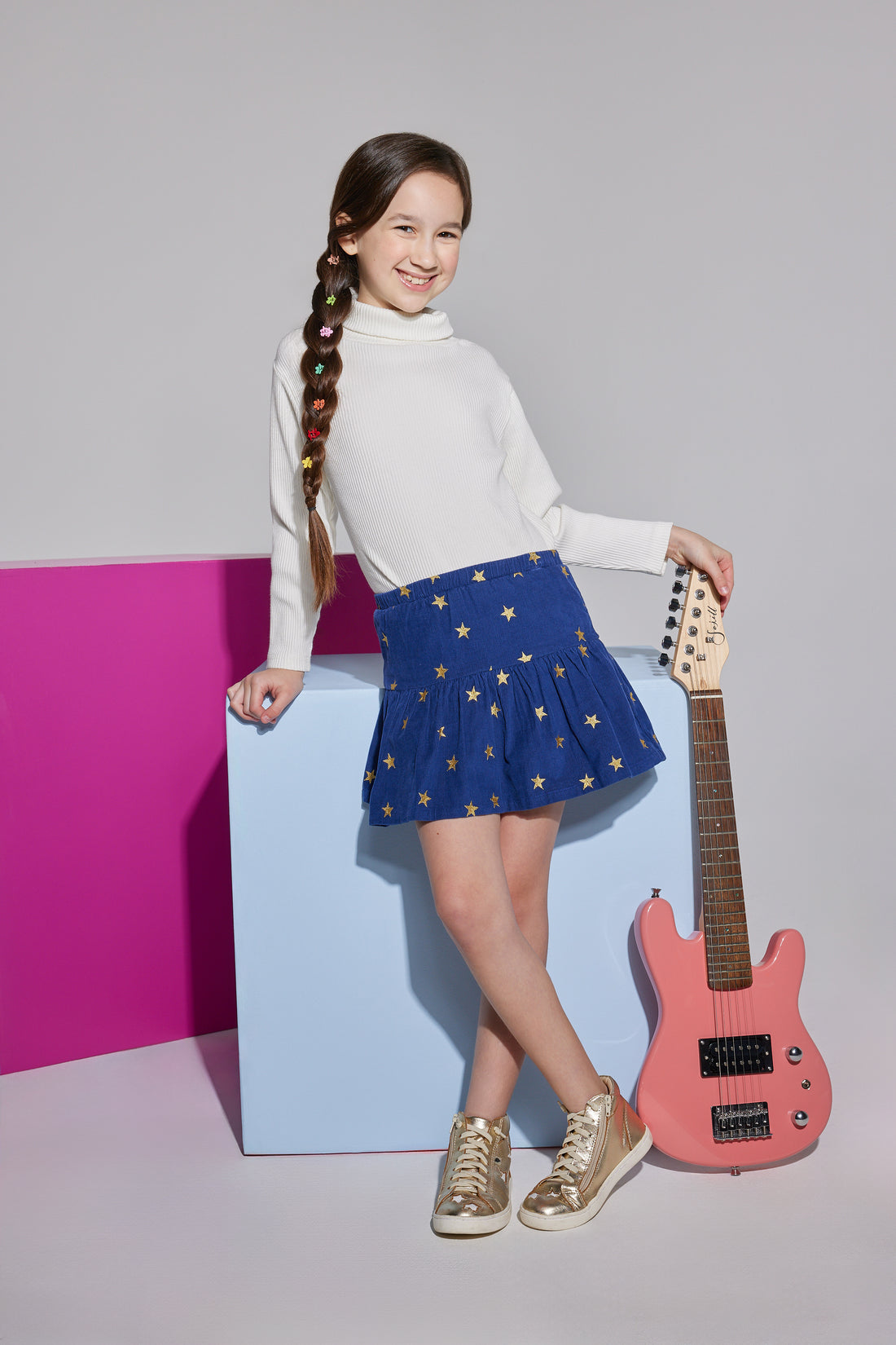 Girls/Tween skirt in navy with gold stars printed on it which also features an elastic waistband and built in shorts for a relaxed comfy fit. This skirt can go back with the ribbed turtleneck in ivory to complete the look.