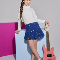 Girls/Tween skirt in navy with gold stars printed on it which also features an elastic waistband and built in shorts for a relaxed comfy fit. This skirt can go back with the ribbed turtleneck in ivory to complete the look.