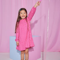 Girls/tween knit long sleeve dress with ruffle neckline and single button closure at back of neck and elastic cuffs on sleeves featuring a hot pink base with light pink floral print.