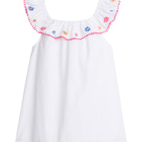 Girl/tween tank top with ruffle neckline and yellow, blue, pink embroidery, also has pink pom poms around the neckline