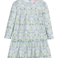 Girls/tween woven long sleeve dress in a blue/green/white floral print. Dress features two tiers and pleating detail and button closure at back for easy put on/take off access.