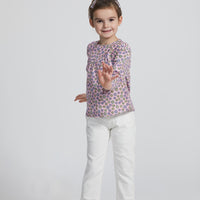 Girl/Tween woven long sleeve top in a pink/purple/yellow floral pattern. Top features button closures along back for a relaxed but secure fit.Model can also be seen wearing our ivory denim jeans to complete the look.