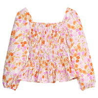 Girls/tween pink/orange floral patterned blouse with long sleeves that features elastic ruching across body of shirt and elastic cuffs for a secure but relaxed fit.