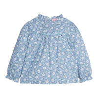 Girls/Tween top in our Bedford Gardens Blue floral which features a blue/aqua/white floral arrangement. Top has an aqua trim detail along the bust, elastic cuffs on the sleeves, ruffles at the neckline, and there are buttons along back as well -BISBY