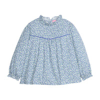 Girls/tween woven long sleeve top in a blue floral print that features a high neck ruffle neckline, button closure at back, and a blue trim detail across the bust to elevate the look.