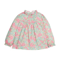 Girls/tween woven long sleeve top in a pink/green/teal floral print that features a high neck ruffle neckline, button closure at back, and a pink trim detail across the bust to elevate the look.