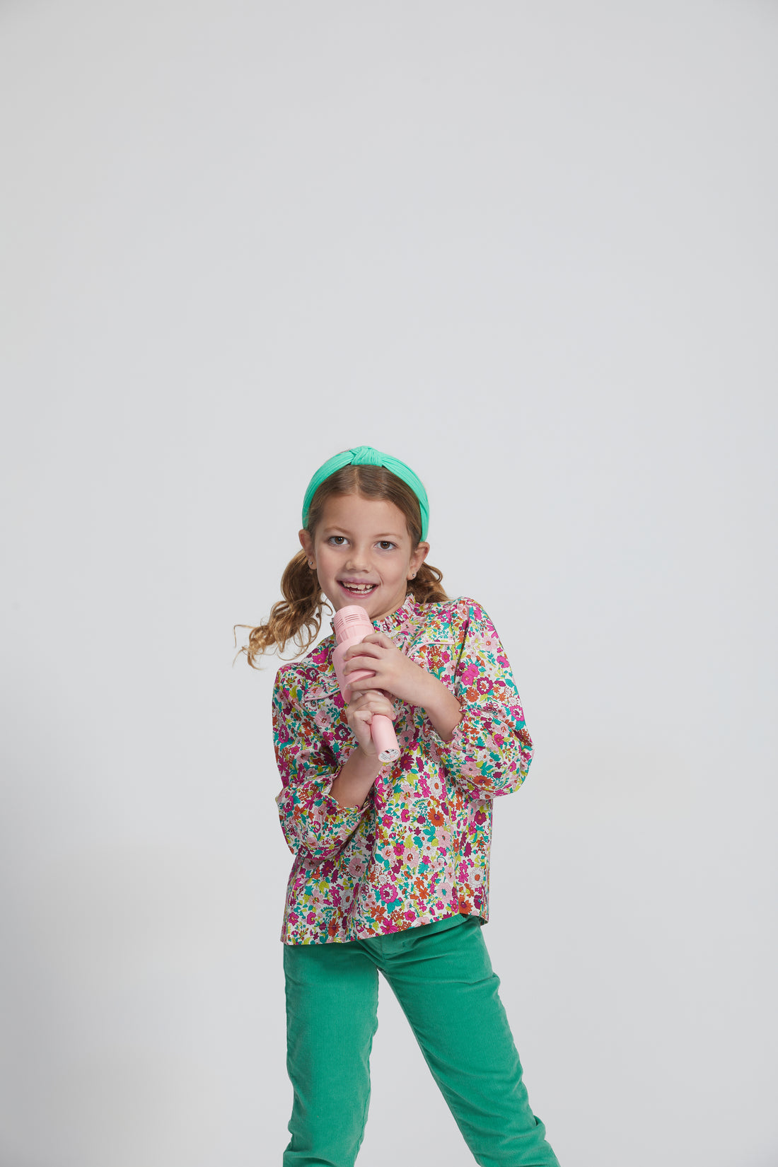 Girls/Tween lightweight corduroy pants in a pine green that feature a button snap closure for easy put on access and also has pockets in the front and back. Model can be seen wearing a woven long sleeve top in a beautiful floral to complete the look.