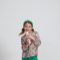 Girls/Tween lightweight corduroy pants in a pine green that feature a button snap closure for easy put on access and also has pockets in the front and back. Model can be seen wearing a woven long sleeve top in a beautiful floral to complete the look.