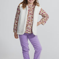 Girls/Tween lightweight corduroy pants in lilac. Pants have a button clasp closure for easy pull on access and has pockets as well. Paired back perfectly with our woven long sleeve top in a magenta floral pattern with a reversible sherpa vest to finish off the look.