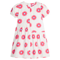 Girls/Tween woven asymmetrical cut dress in white with big red/blue flowers printed on it. The cuffs at sleeves are elastic and there is a zipper along back for a relaxed but secure fit.