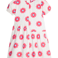 Girls/Tween woven asymmetrical cut dress in white with big red/blue flowers printed on it. The cuffs at sleeves are elastic and there is a zipper along back for a relaxed but secure fit.