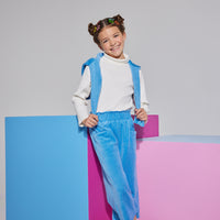 Girls/Tween ribbed turtleneck in ivory which is made of a super soft knit ribbed material and is perfect for layering. Model can be seen wearing cropped velour pants in French blue which feature an elastic waistband and pockets in the front which has a matching pullover in the same material and color thrown over the shoulders to complete the look.