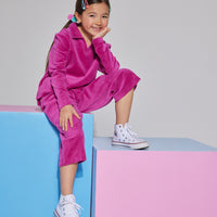 Girls/Tween velour pullover in a magenta color. The pullover features a v-neck neckline and a collar, so girls can wear a turtleneck underneath if desired. Paired back perfectly with the matching cropped velour pants in the same magenta shade.