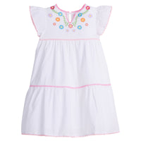 Girls/Tween woven white tiered dress with multi-color floral embroidery detail on chest/along the v-neck neckline. Dress also features light pink pom poms along sleeve and first and bottom tiers of dress. A row of bubblegum pink pom poms is seen along the second tier of dress and around neckline. There is also a button closure at back of neckline for a secure fit.