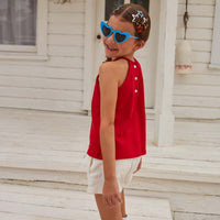 Red halter top with button enclosures on back paired with our denim shorts in ivory. Perfect for a summer or Fourth of July fit.