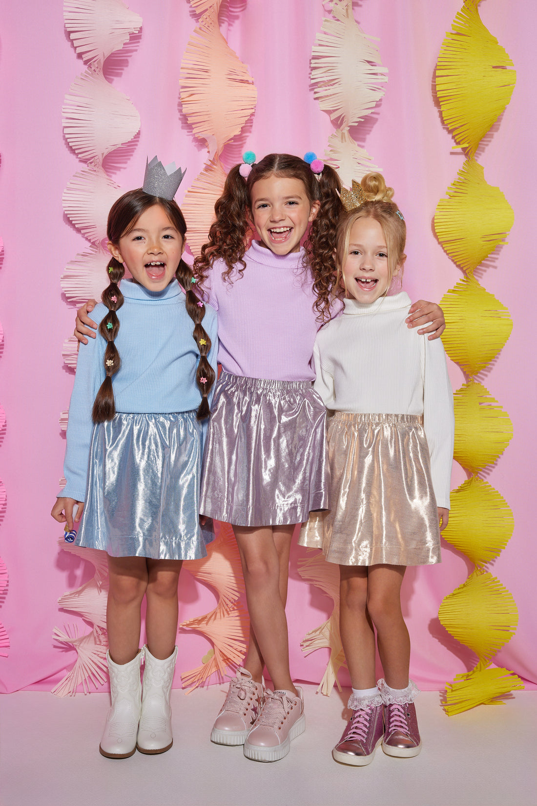 Models can be seen in our circle shorts in an ice blue, purple, and gold metallic colors. Each skort has built in shorts for a secure fit and all have matching ribbed turtlenecks paired back with them.