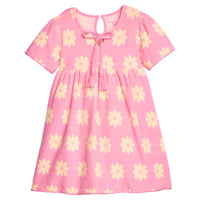 BISBY girl terry knit dress in bubblegum pink with yellow floral pattern. Dress features a keyhole button closure at back, tie tassel feature at v-neckline, and pink pom pom details at sleeve ends and bottom of dress to elevate the look.