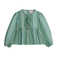 Girls/tween woven long sleeve top in a green/blue floral print. Top features tie tassel detail at neckline, elastic cuffs at sleeves, and button closures at back.