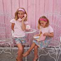 BISBY girl Rosie Short Set in Tulip Garden. Top is pink and white stripe with angel sleeve paired with our shorts in our Tulip Garden colorful floral which pairs perfectly with our Rosie Dress in Tulip Garden. Top half of dress is knit pink and white stripe with a woven bottom half in our Tulip Garden floral print