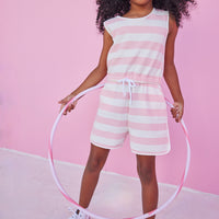 Girl/tween woven romper with pockets and elastic tie waistband with thick light pink and white stripes.