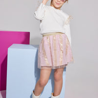 Girls/Tween skort in out Pink Metallic Stars and Stripes pattern. Skort is made of a woven light pink base fabric with a tulle overlay that has gold stars all over. Skort also has built in shorts and an elastic waistband in a gold glitter material. Pair back perfectly with our ivory knit long sleeve top with the same tulle fabric as angel sleeves to complete the look.