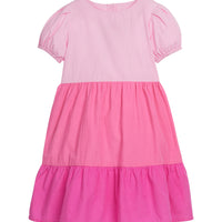 Girls/Tween color block woven dress with the top section in a light pink, middle tier in a pink color, and the bottom tier in a hot pink color.