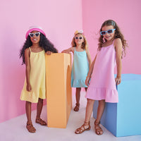 Girl/tween dress with thin stretchy straps and a waffle knit pattern, all in a solid Yellow/Popcorn color.