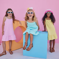 Girl/tween dress with thin stretchy straps and a waffle knit pattern, all in a solid pink color.