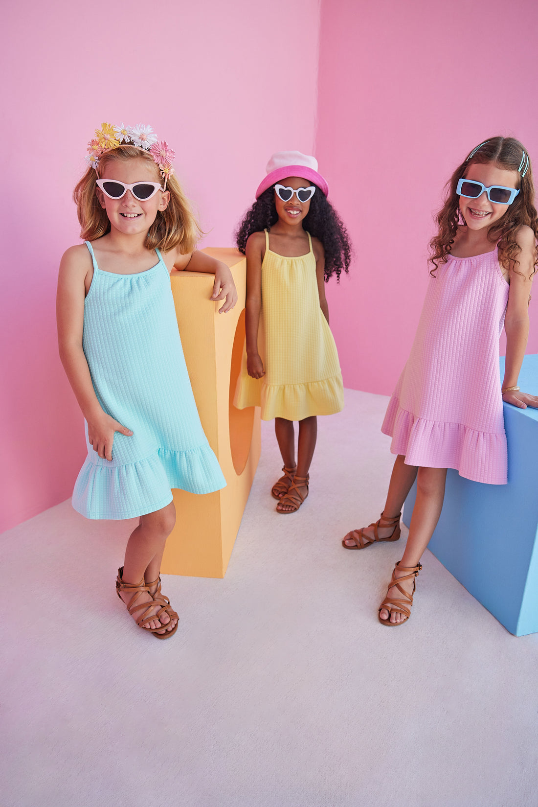 Girl/tween dress with thin stretchy straps and a waffle knit pattern, all in a pink solid color.