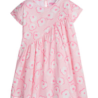 Girl/Tween woven dress in light pink/hot pink/white floral print. This fun dress has a "swoop" ruching detail along the front side for a different/ fun shape. Dress also has a button closure at back for a secure but relaxed fit.