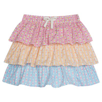 Tiered skort with built in shorts and elastic waistband with faux tie. Top tier of skirt has pink daisy pattern, middle tier has orange daisy pattern, and bottom tier has light blue daisy pattern.