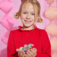 Girls/Tween knit dress in red features a 3 button closure on back with a ruffle neckline at the collar for a relaxed but secure fit. Dress is made of a super soft/stretchy material for easy play while wearing.