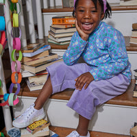 Little girl seen wearing our Lilac Corduroy Cropped Palazzo pants paired with our Turtleneck in Seville Azul---BISBY girl