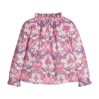Girls/tween woven top in pink/purple floral print that features an elastic high neck collar and elastic cuffs at sleeves for a secure but relaxed fit.