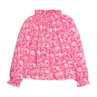Girls/tween rayon top in pink/red/white floral print that features an elastic high neck collar and elastic cuffs at sleeves for a secure but relaxed fit.