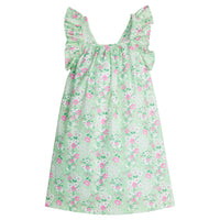 Girl/Tween woven dress with adjustable ruffle straps and has a light green/white/pink floral pattern.