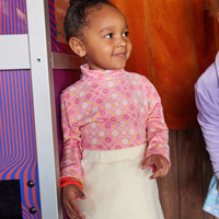 Pink cream and orange floral printed turtleneck for girls by BISBY