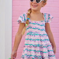 BISBY girl in our new Twirl Dress in our Alli Stripe. This dress features smocking on the bust and has angel sleeves for a more elevated look. Made from a super soft material, this pink/green/ and cream dress is the perfect, comfortable, flowy dress for summer.