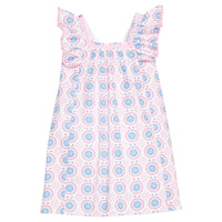 BISBY girl woven dress in a white/pink/red/blue fun pattern. Dress features a square neckline with a light pink ribbon trim, three button closure at back, angel sleeve detail, and light pink pom poms along edge of sleeves for an elevated look.