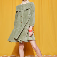 Little girl can be seen wearing our Sage Green Corduroy Western styled dress paired with our essential Tan turtleneck underneath--BISBY girls