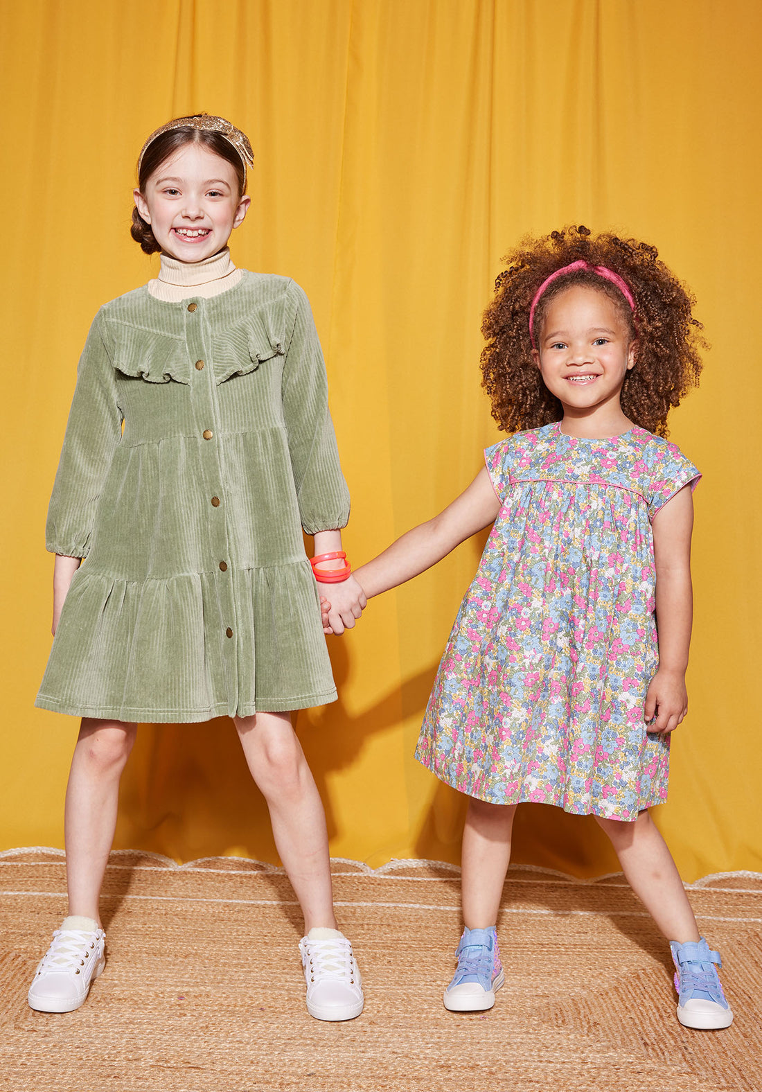 Little Girls seen wearing our Charlotte Dress in Merion Floral (right and our Western Dress in sage Green (on left)--BISBY girls