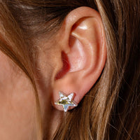 A girl wearing star shaped earrings