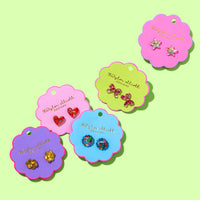 Colorful earring display cards with earrings on a light green background
