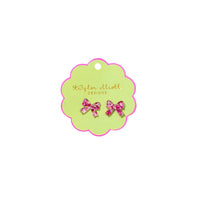 Green card with pink bow earrings on a white background